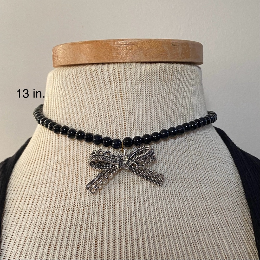 Elegant Black Beaded Necklace with Silver Bow Pendant